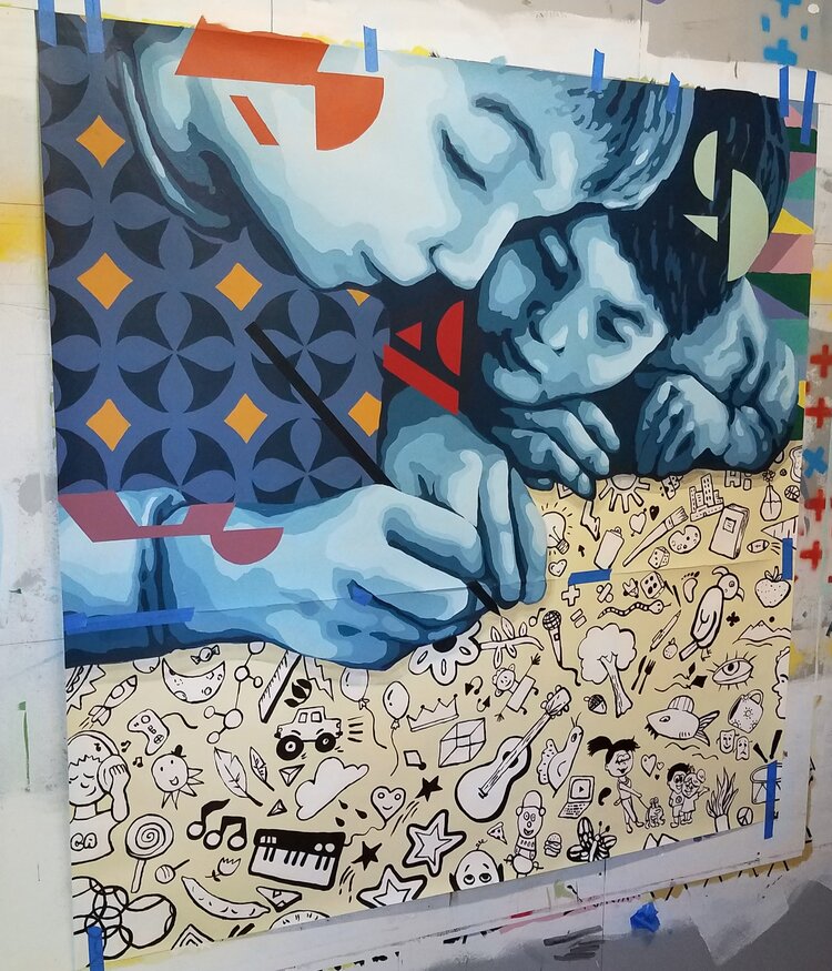A mural by Matt Halm depicting two children sitting close together and drawing illustrations on a piece of paper